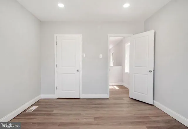 a view of an empty room and wooden floor