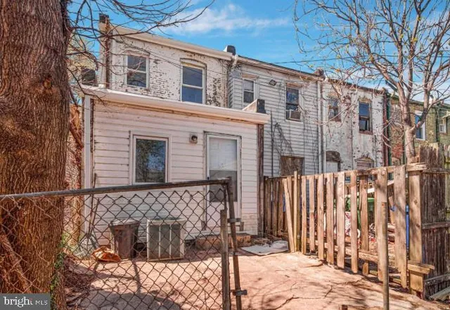 a front view of a house with a tree