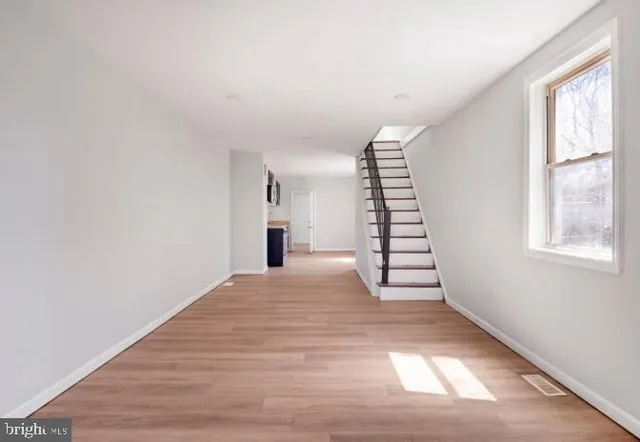 a view of an empty room with windows