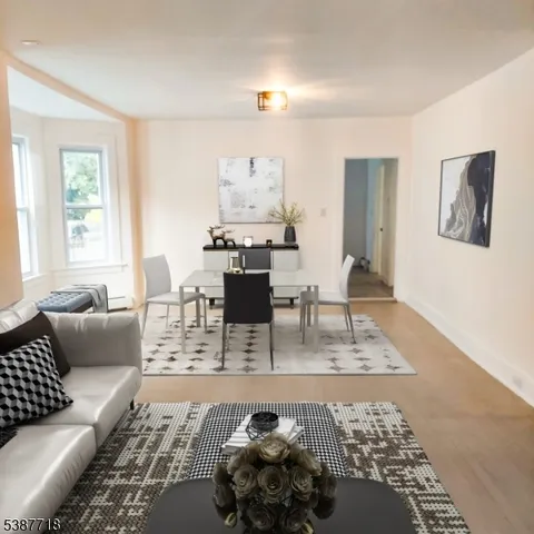 a living room with furniture a wooden floor and a table