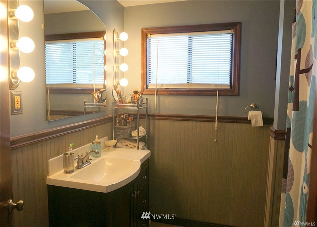 2124 7th Street Bremerton, WA 98312 - Photo 11 of 17 a bathroom with a sink and a mirror