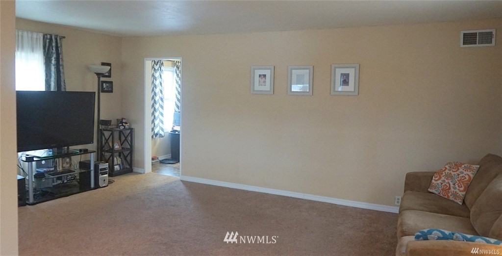 2124 7th Street Bremerton, WA 98312 - Photo 7 of 17 a living room with furniture and a flat screen tv