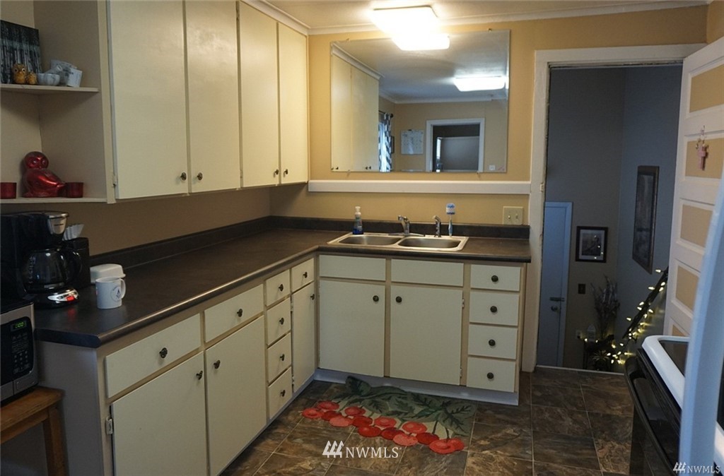 2124 7th Street Bremerton, WA 98312 - Photo 8 of 17 a kitchen with cabinets appliances and wooden floor