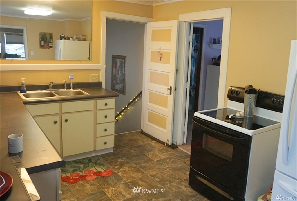 2124 7th Street Bremerton, WA 98312 - Photo 9 of 17 a kitchen with stainless steel appliances granite countertop a stove a sink and a refrigerator