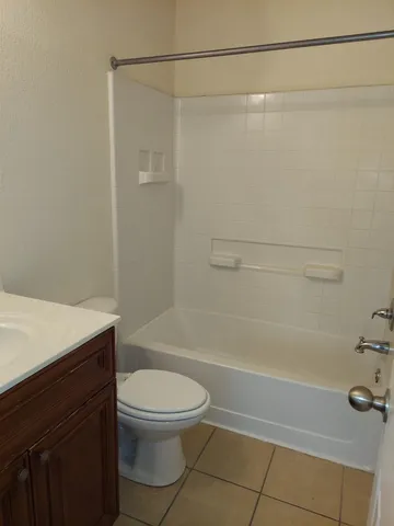 a bathroom with a shower a toilet and a sink