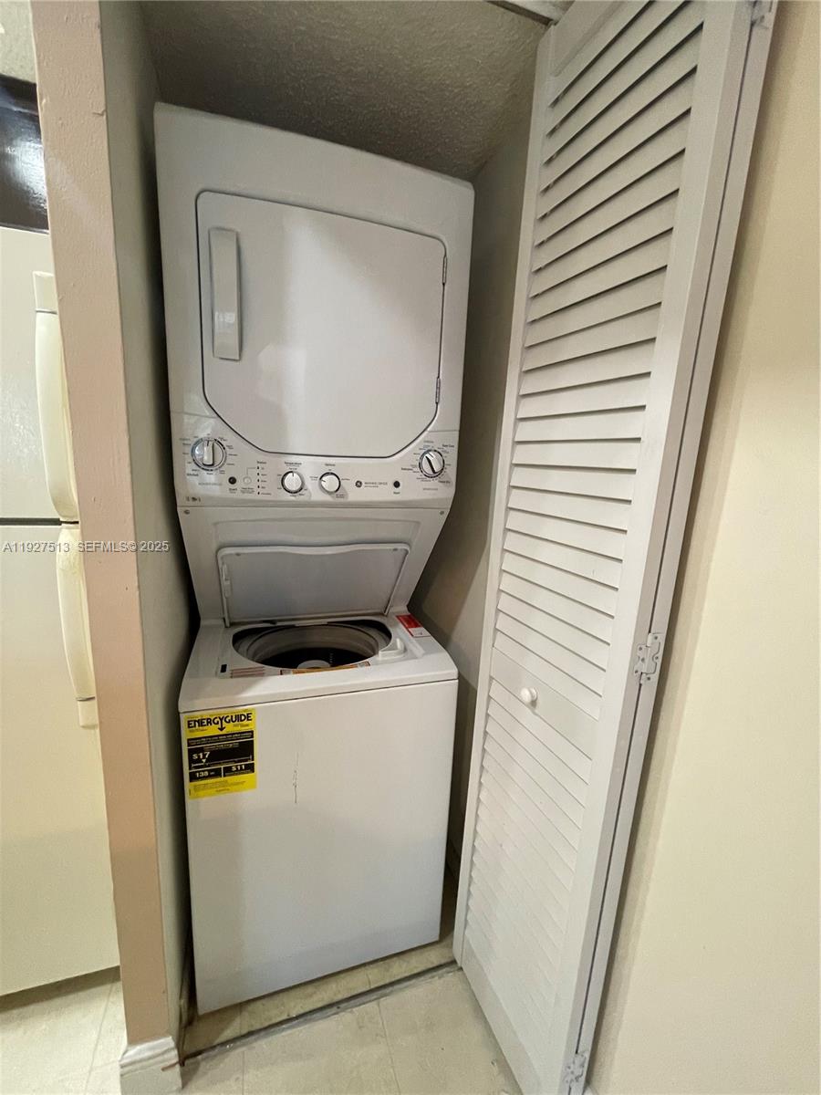 5686 Rock Island Road, Unit 114 Tamarac, FL 33319 - Photo 15 of 32 a utility room with dryer and washer