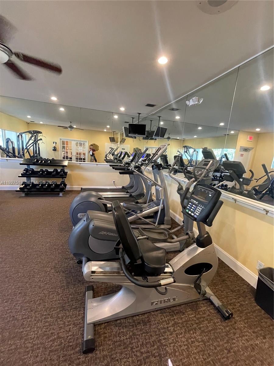 5686 Rock Island Road, Unit 114 Tamarac, FL 33319 - Photo 25 of 32 a view of a room with gym equipment