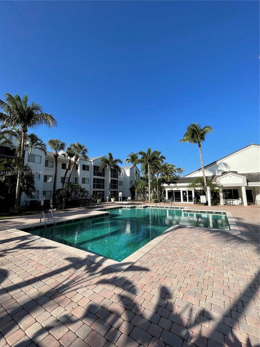 5686 Rock Island Road, Unit 114 Tamarac, FL 33319 - Photo 31 of 32 a view of a house with a yard and sitting area