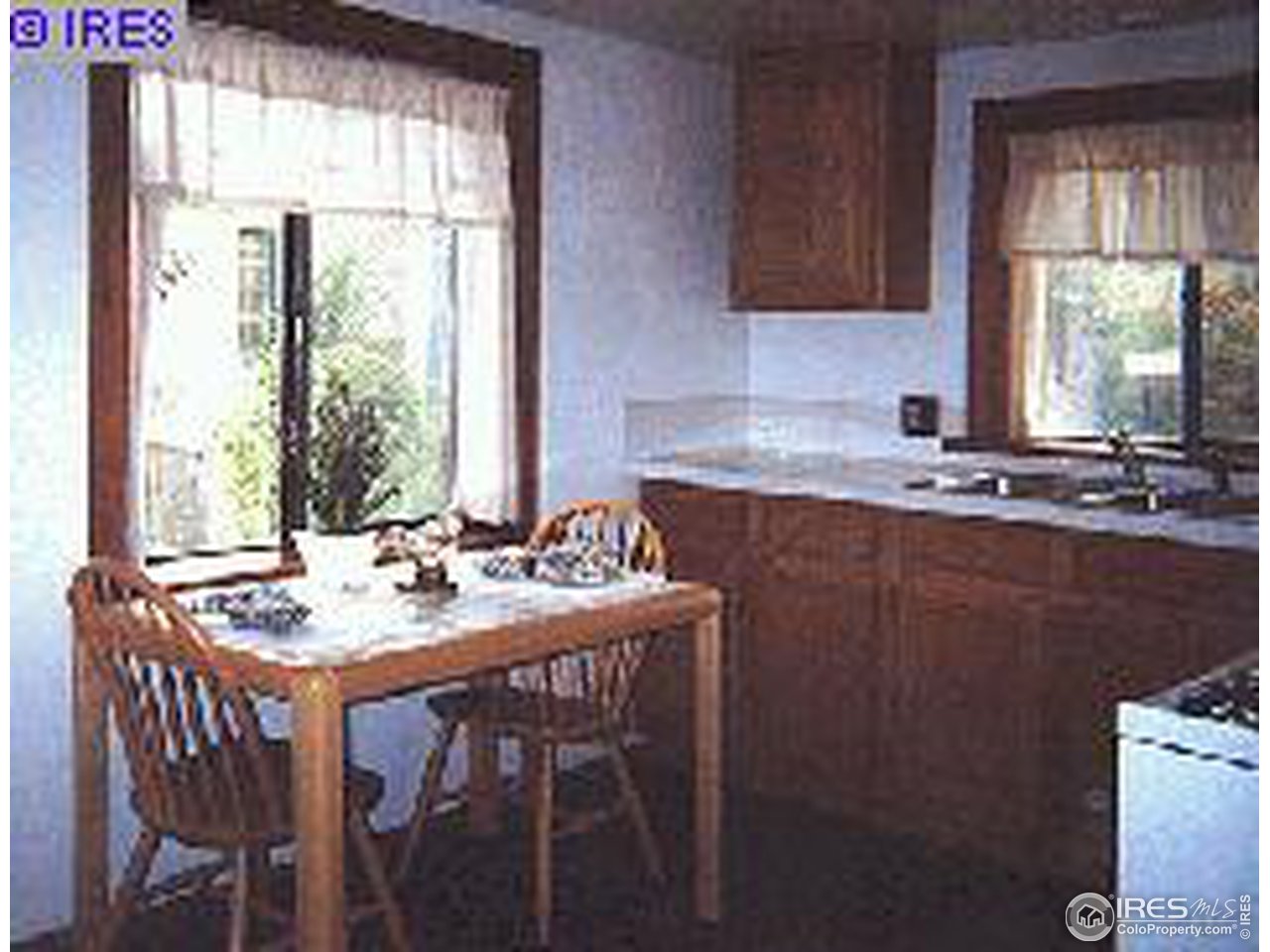 405 East Baseline Road Lafayette, CO 80026 - Photo 4 of 4 a kitchen with a sink a window and chairs
