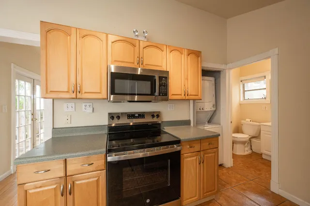 a kitchen with a stove a sink and a microwave