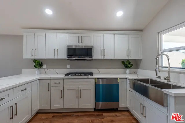 a kitchen with a sink stove and cabinets