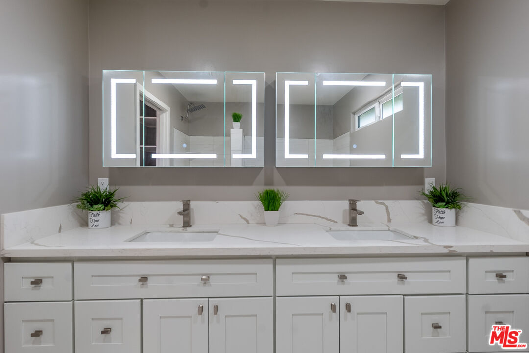 20456 Strathern Street Winnetka, CA 91306 - Photo 24 of 37 a bathroom with a sink and a mirror