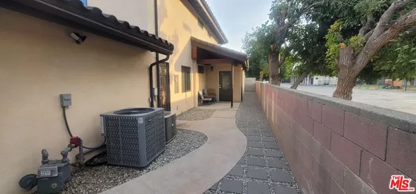 a couple of potted plants sitting in front of a house