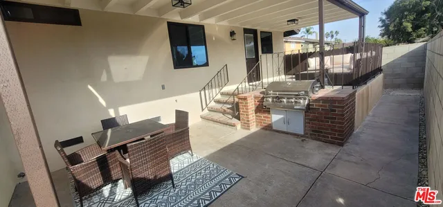 a view of living room kitchen and entryway