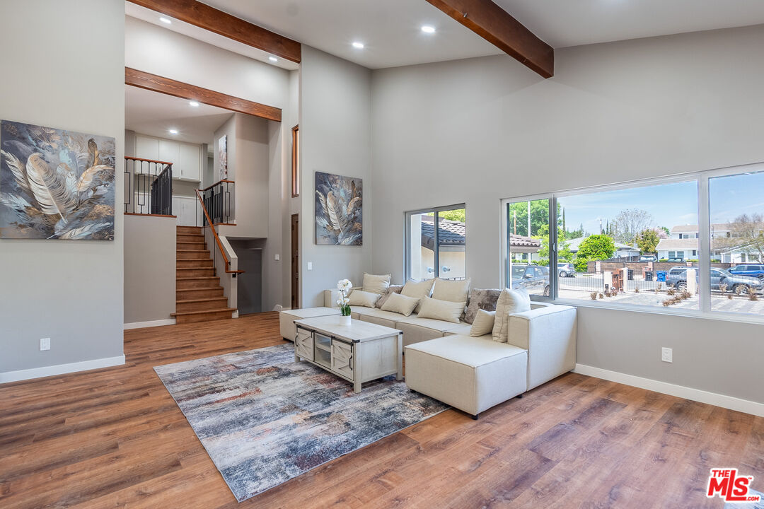 20456 Strathern Street Winnetka, CA 91306 - Photo 8 of 37 a living room with furniture and a wooden floor