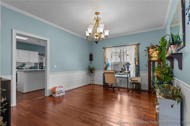a kitchen with granite countertop white cabinets and stainless steel appliances