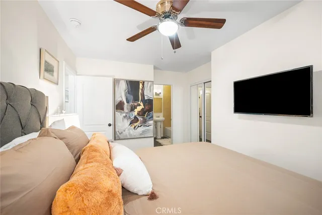 a bedroom with a large bed and a window