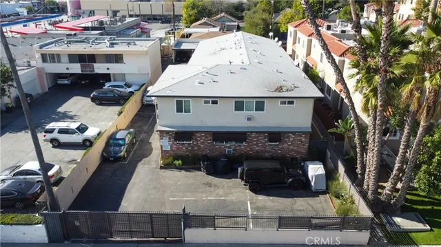 a roof deck with table and chairs a barbeque