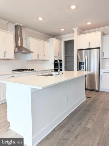 a view of a kitchen with wooden floor and stairs