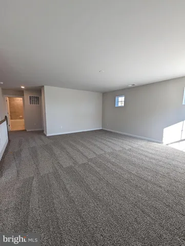 a view of kitchen with stainless steel appliances cabinets and a refrigerator