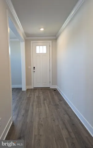 a large kitchen with stainless steel appliances a large counter top a stove and a refrigerator