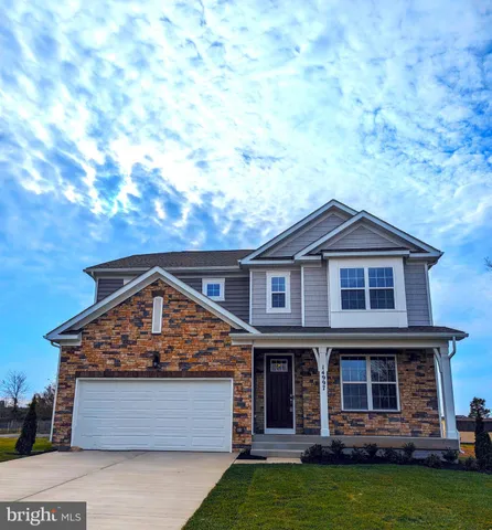 a large kitchen with stainless steel appliances a large counter top a stove and a refrigerator