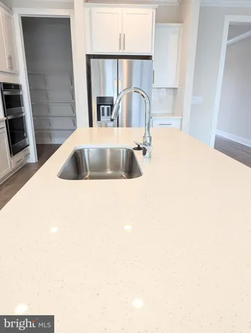 a stove top oven sitting inside of a kitchen