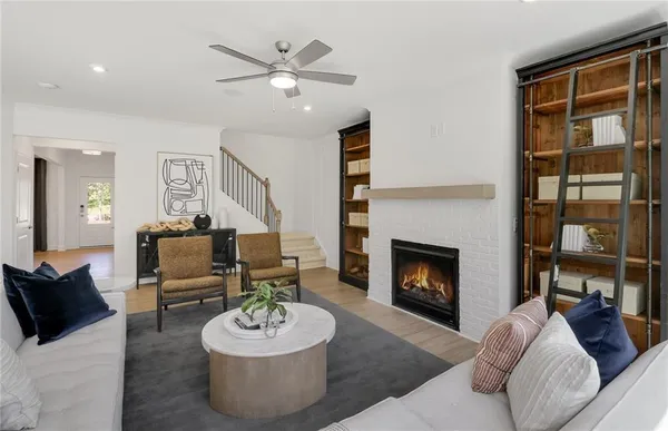 a living room with furniture and a fireplace