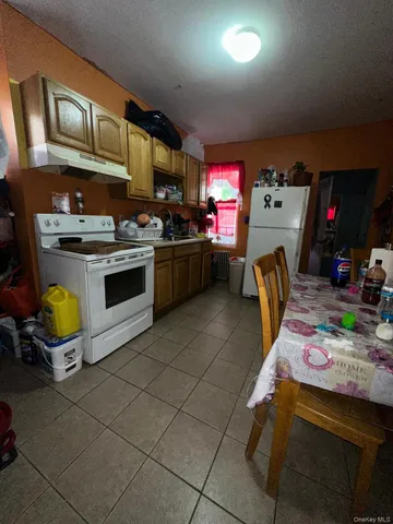 a kitchen with granite countertop a sink a stove and cabinets