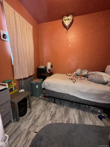 a bedroom with a bed and a lounge chair