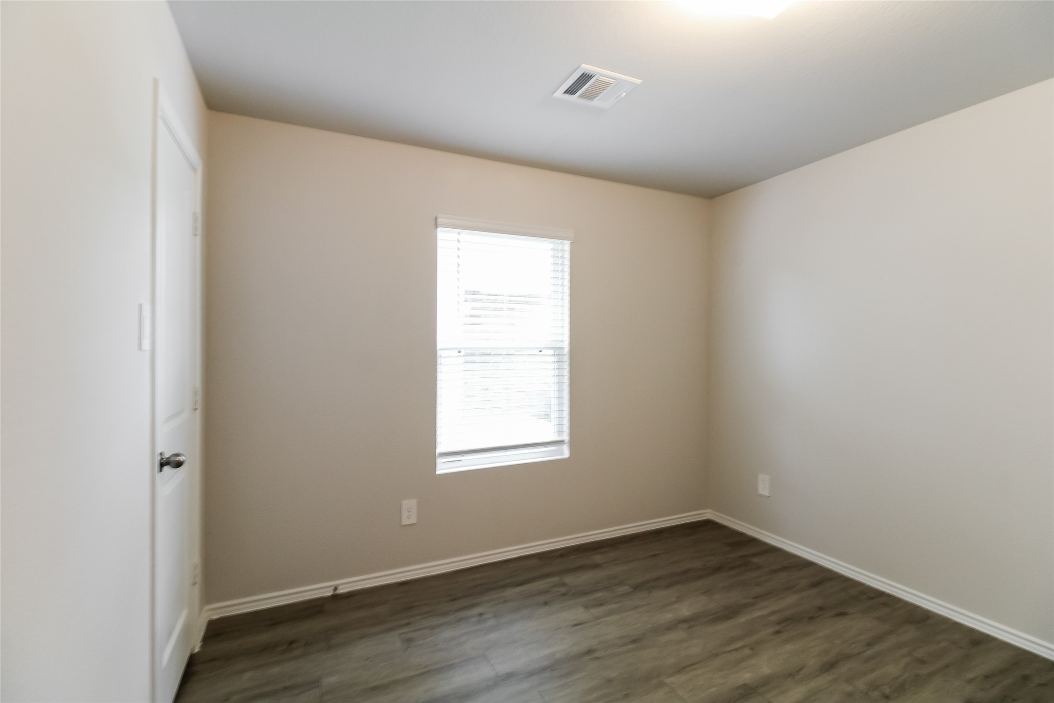 2528 Shad Drive Conroe, TX 77384 - Photo 10 of 16 an empty room with wooden floor and windows