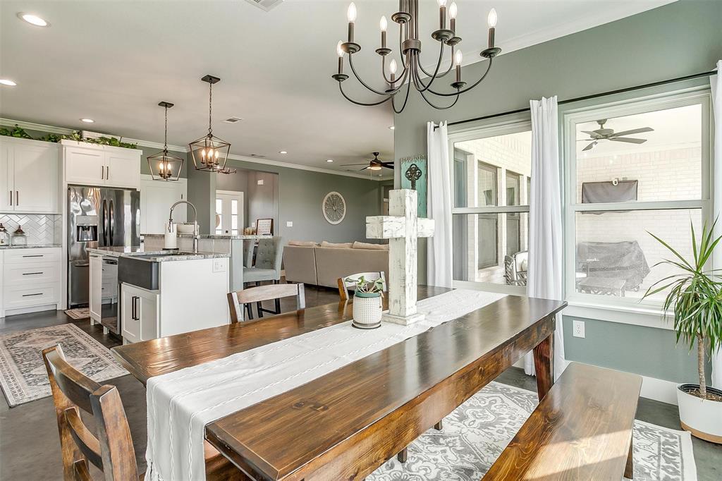 3095 County Road 905 Joshua, TX 76058 - Photo 11 of 38 a room with stainless steel appliances kitchen island granite countertop furniture and a wooden floor