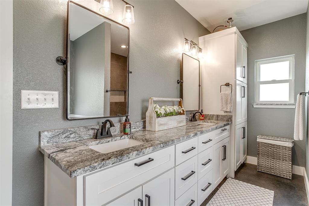 3095 County Road 905 Joshua, TX 76058 - Photo 18 of 38 a bathroom with a granite countertop sink and a mirror