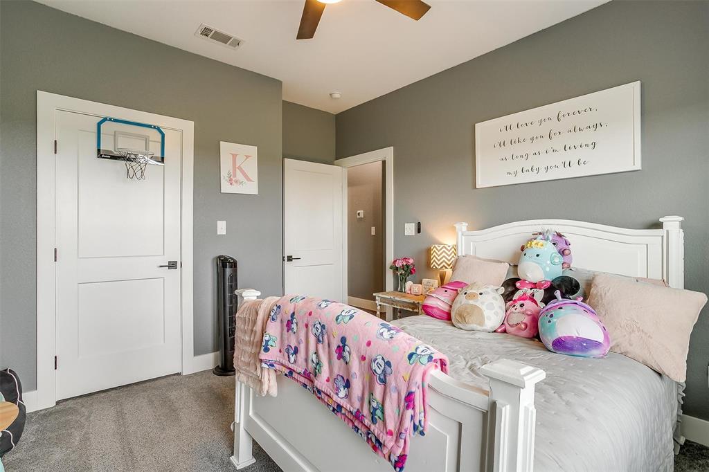 3095 County Road 905 Joshua, TX 76058 - Photo 21 of 38 a bedroom with a bed and a chandelier