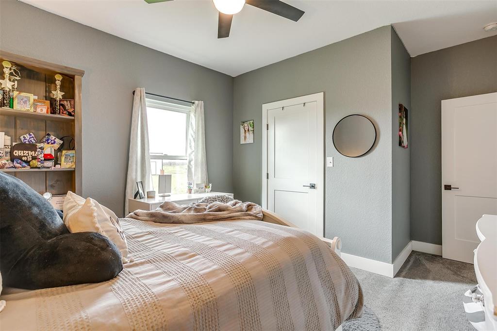 3095 County Road 905 Joshua, TX 76058 - Photo 23 of 38 a bedroom with a bed and a chandelier