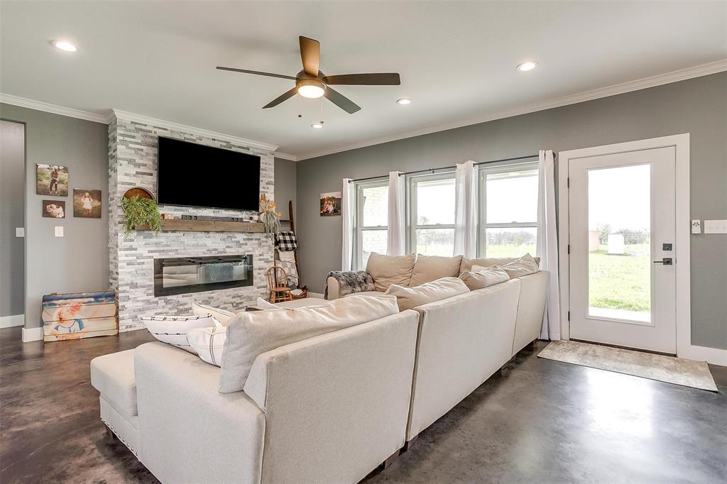 3095 County Road 905 Joshua, TX 76058 - Photo 4 of 38 a living room with furniture a flat screen tv and a fireplace