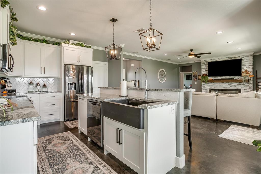 3095 County Road 905 Joshua, TX 76058 - Photo 8 of 38 a kitchen with stainless steel appliances granite countertop a sink a stove and a refrigerator