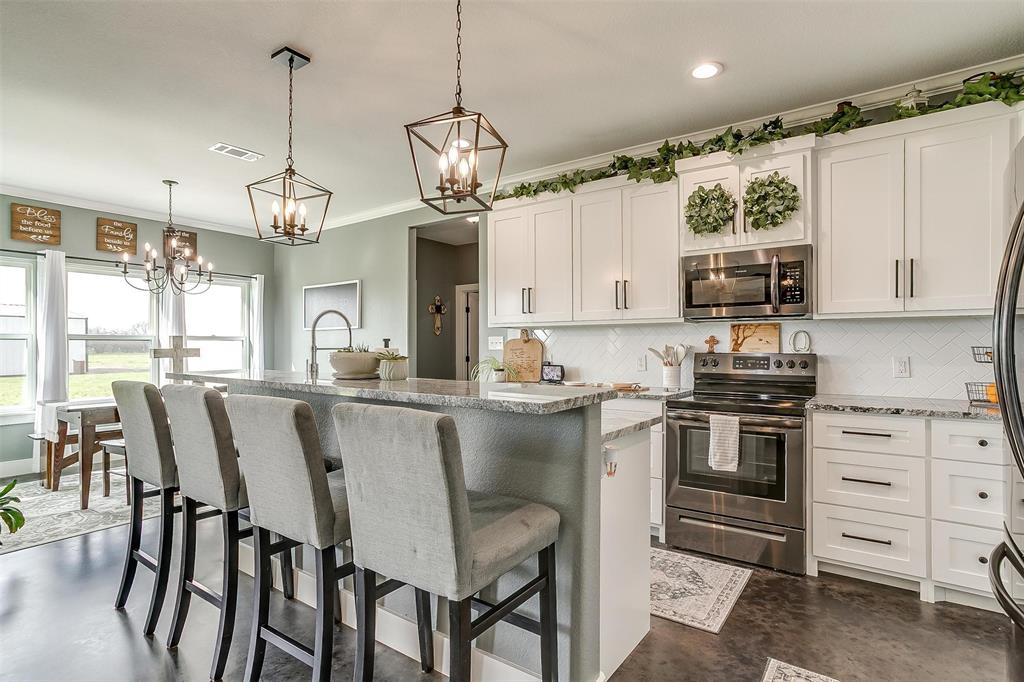 3095 County Road 905 Joshua, TX 76058 - Photo 9 of 38 a kitchen with microwave a stove and furniture