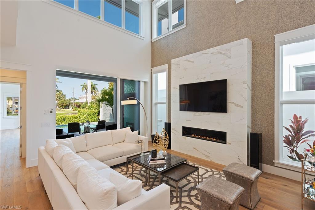 770 Park Street Naples, FL 34102 - Photo 2 of 34 a living room with fireplace furniture and a flat screen tv