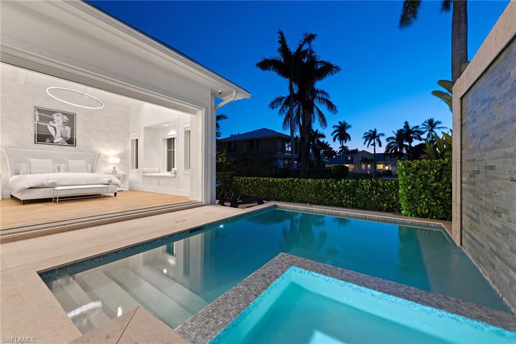 770 Park Street Naples, FL 34102 - Photo 29 of 34 a view of swimming pool with a lounge chair and potted plants