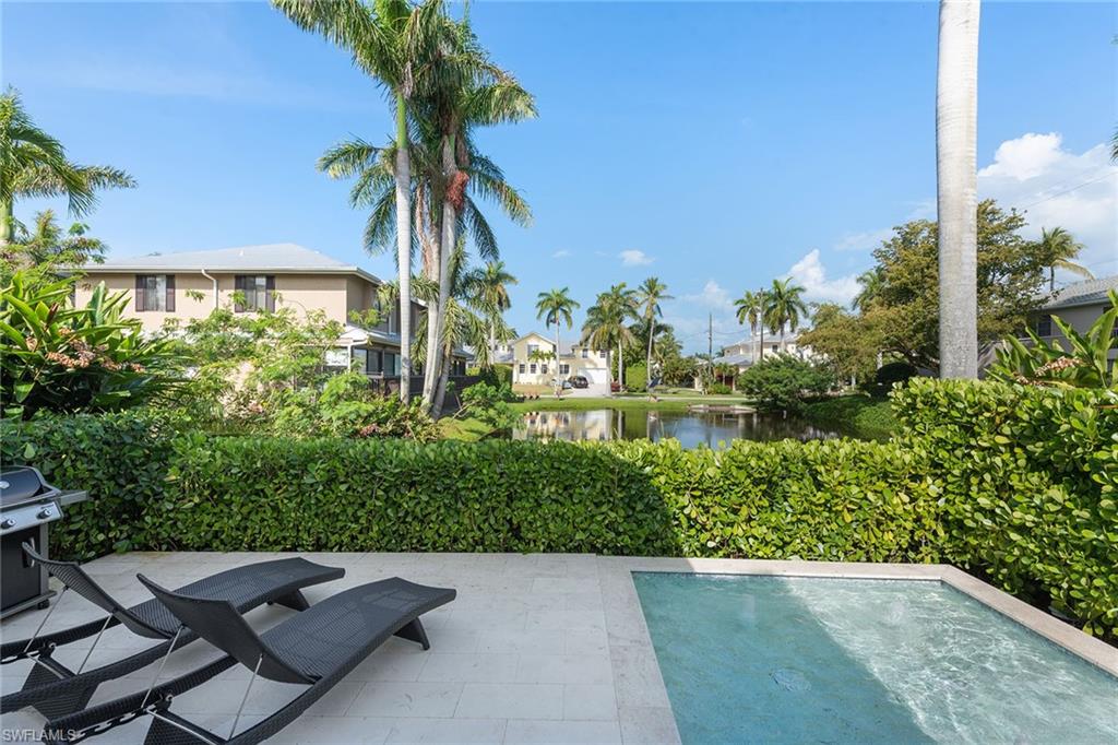 770 Park Street Naples, FL 34102 - Photo 32 of 34 a view of backyard with outdoor seating and green space