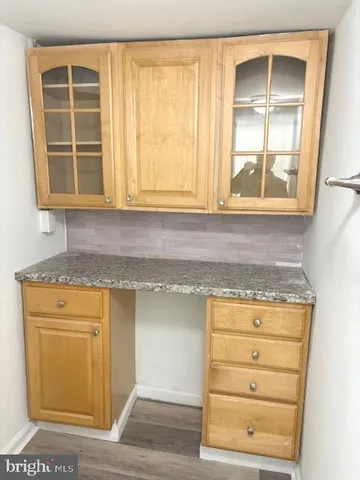 a kitchen with granite countertop cabinets appliances and a window