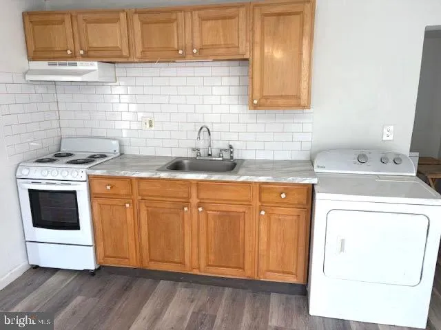 a kitchen with granite countertop cabinets stainless steel appliances and sink