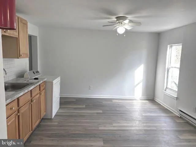 a view of a kitchen with a sink dishwasher and a fireplace