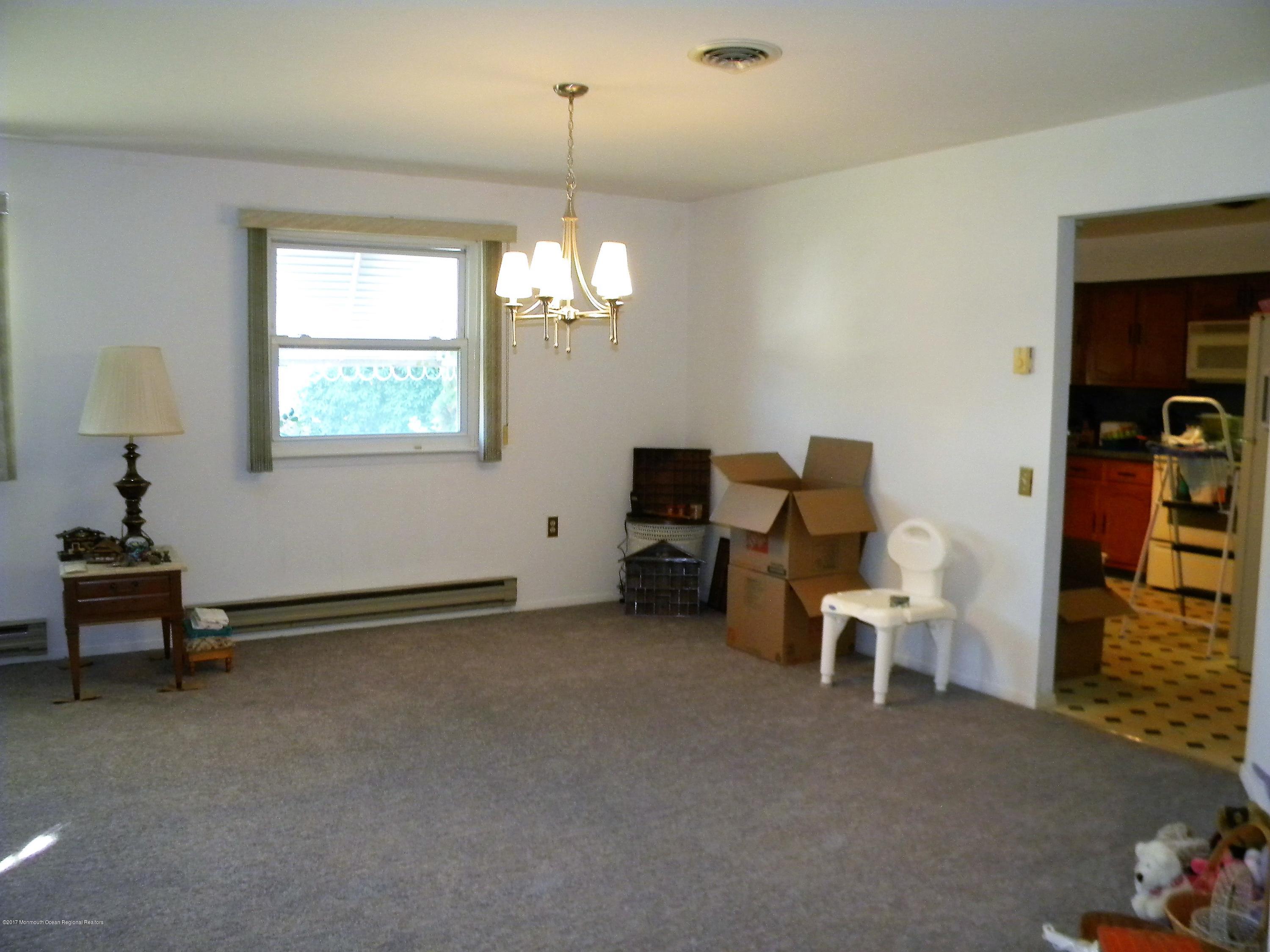 120 Sunset Road, Unit 60 Whiting, NJ 08759 - Photo 7 of 24 a living room with furniture and a chandelier