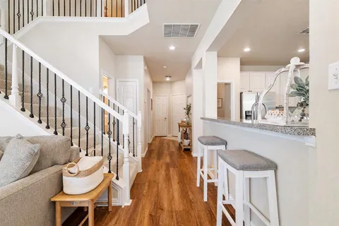a view of a hallway with furniture and stairs