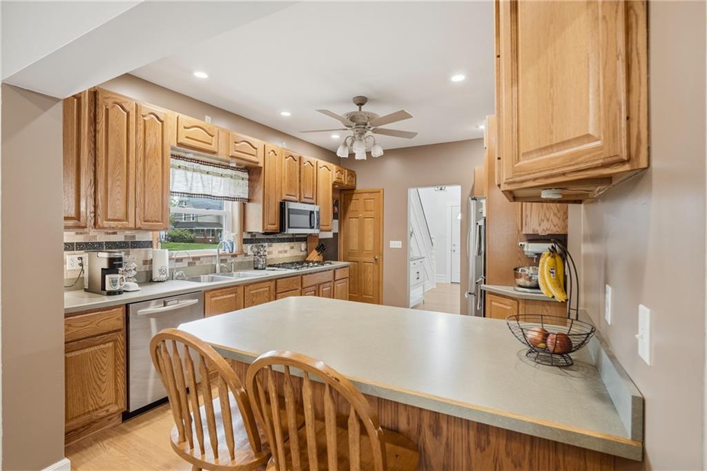 519 West Ridge Avenue Sharpsville, PA 16150 - Photo 15 of 48 a kitchen with stainless steel appliances granite countertop a sink dishwasher stove and refrigerator with wooden floor
