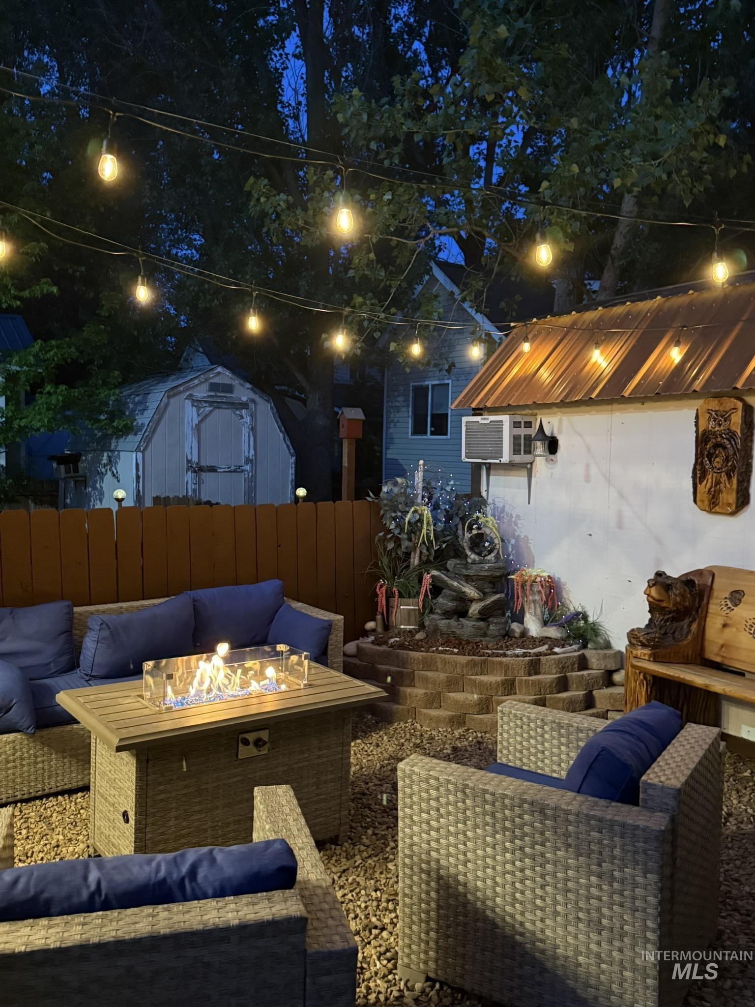 29 B Street Cascade, ID 83611 - Photo 21 of 24 Patio at night featuring an outdoor living space with a fire pit, a storage unit, and a patio