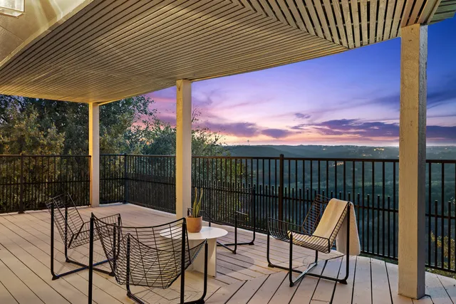 a view of a chairs and table in the balcony