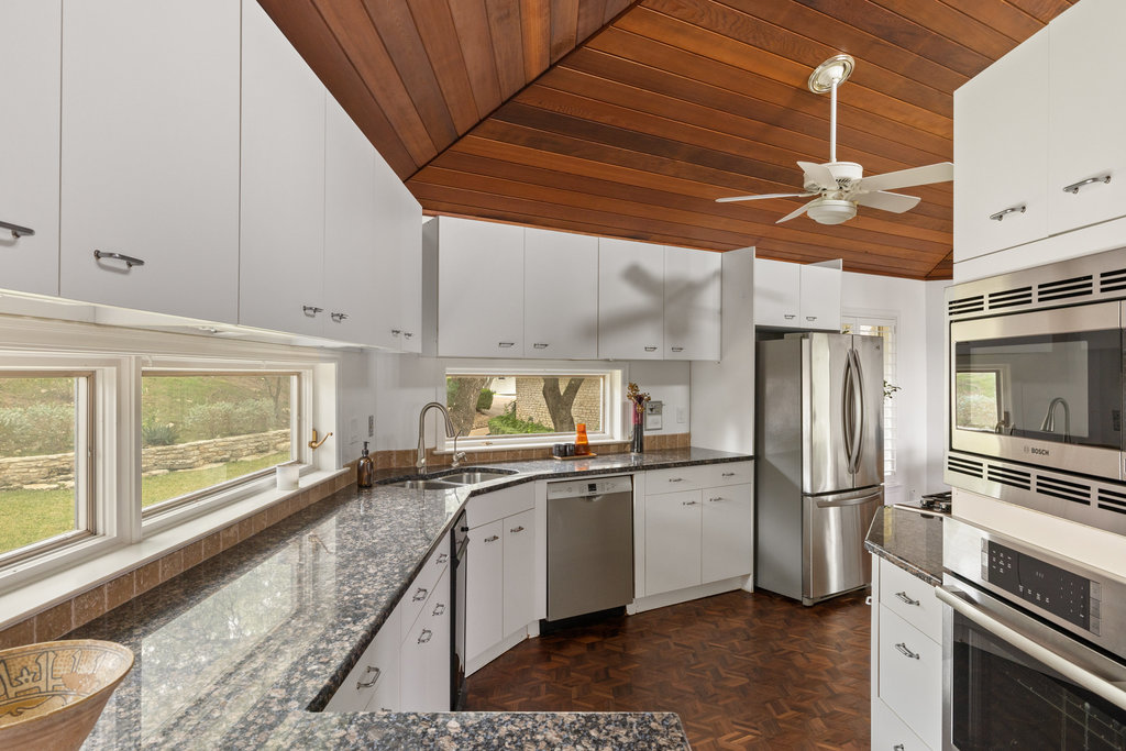 1922 Cypress Point West Austin, TX 78746 - Photo 16 of 38 a kitchen with a sink stainless steel appliances and cabinets